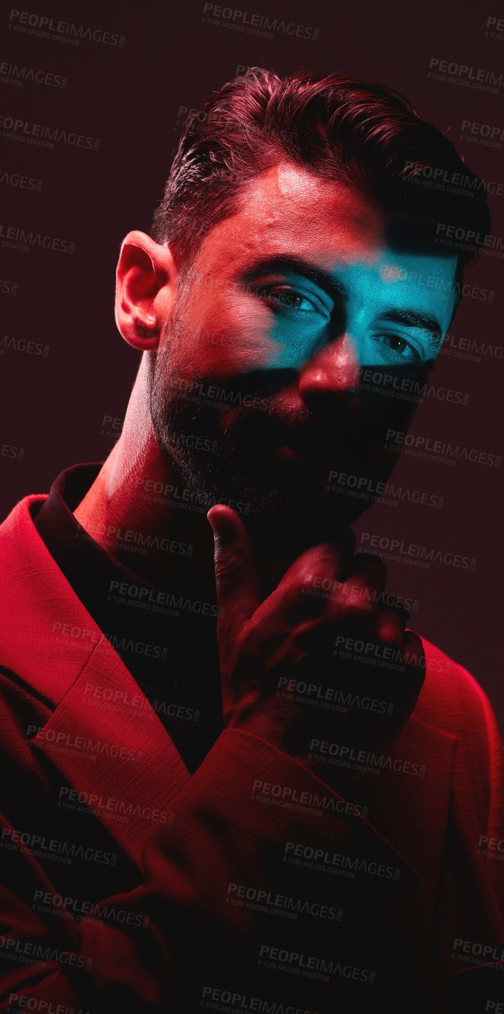 Buy stock photo Future, fashion and reflection, portrait of man with eyes in neon lighting with serious expression on face. Futuristic art, male model and beauty with red and blue studio lights on dark background.