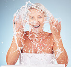 Shower, face and old woman with smile and water splash, clean skin and antiaging beauty, elderly model isolated on studio background. Senior skincare, cosmetics and facial portrait, happy and hygiene