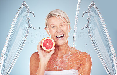Buy stock photo Woman, grapefruit and studio portrait with water splash, happiness and cosmetics for wellness by blue background. Senior model, citrus fruit and vitamin c for health, nutrition and self care process
