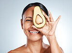 Beauty, avocado and portrait of woman in studio happy, detox and nutrition on grey background. Fruit, product and face of girl model relax, facial and vegan skincare, skin and and mask while isolated