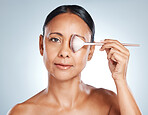 Makeup brush, hand and mature woman portrait for skincare, cosmetic luxury and wellness. Blue background, studio and isolated model with cosmetics tools and microblading aesthetic for self care