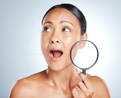Buy stock photo Face, beauty and surprise of woman with magnifying glass in studio isolated on gray background. Wow, makeup cosmetics and mature female with lens, thinking or shocked after skincare facial treatment