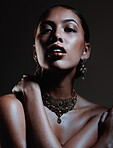 Beauty, jewellery and portrait of a woman in a studio with elegant, fancy and stylish accessories. Cosmetic, style and female model from Mexico with beautiful jewelry posing by a black background.