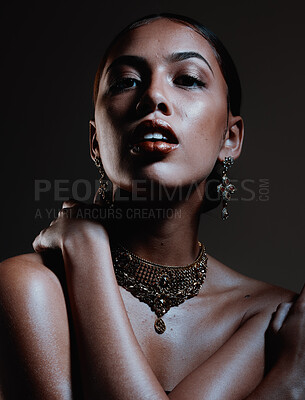 Buy stock photo Beauty, jewellery and portrait of a woman in a studio with elegant, fancy and stylish accessories. Cosmetic, style and female model from Mexico with beautiful jewelry posing by a black background.