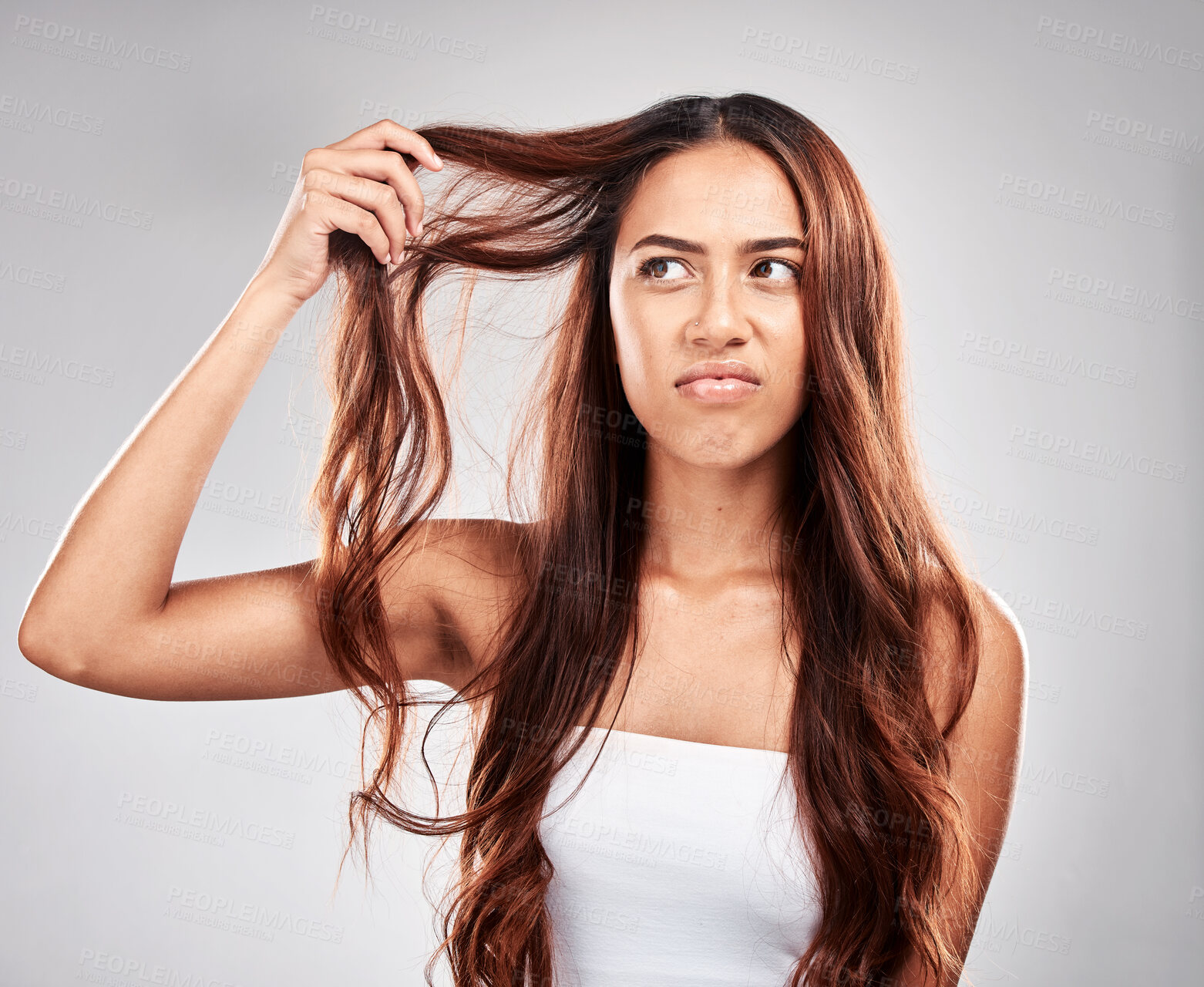 Buy stock photo Woman, hair care and angry face in studio for luxury wellness, damaged hair loss or frustrated. Upset model, salon stress and messy hairstyle mistake, beauty problem or split end in grey background