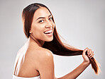 Portrait, happy and woman in studio with strong hair, healthy and salon treatment on grey background. Face, smile and girl model with healthy hair relax after luxury hair care, keratin and isolated