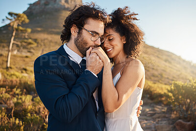Buy stock photo Love, kiss and wedding with couple in nature for celebration, happiness and romance. Sunset, hug and affectionate with bride and groom in embrace at countryside for happy, marriage and smile together