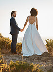 Wedding, nature or a couple of friends holding hands on a mountain in a romantic celebration of love. Interracial marriage, black woman and happy man in a commitment as bride and groom at sunset