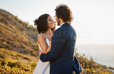 Buy stock photo Marriage, love and bride with groom on mountain for wedding ceremony, commitment and celebration. Romance, happiness and interracial couple bonding, hug and smile with ocean, nature and outdoors