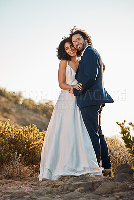 Buy stock photo Wedding bride and groom portrait at sunset with embrace together for love, care and connection in nature. Partner, soulmate and bond of interracial people at outdoor marriage celebration on hill.