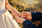 Hands, wedding couple and ring at ceremony outdoor with jewelry and save the date announcement. Engagement, love together and marriage of people in nature at life commitment and engagement event 