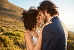 Wedding, interracial couple hug and mountains of people outdoor in nature for marriage and save the date. Prayer, love celebration and bride with man for commitment, care and pray feeling calm