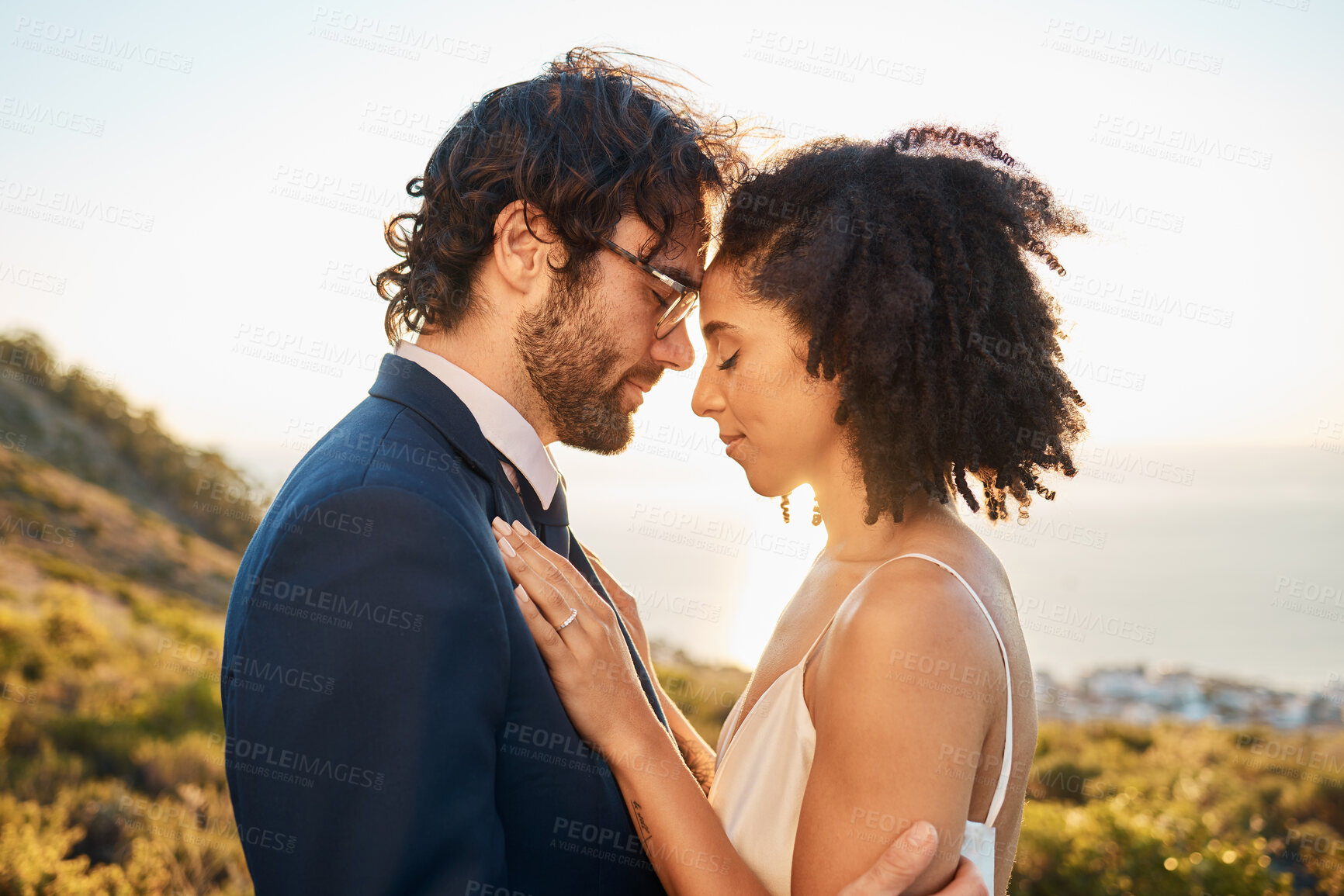 Buy stock photo Wedding, interracial couple love and worship of people outdoor for marriage and save the date. Close, celebration and bride with man for commitment, care together feeling calm in nature