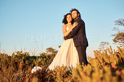 Buy stock photo Bride, groom and wedding in nature at sunset by interracial couple, happy and excited for love, romance and relationship. Marriage, woman and man embracing at outdoor ceremony, in love and sweet joy