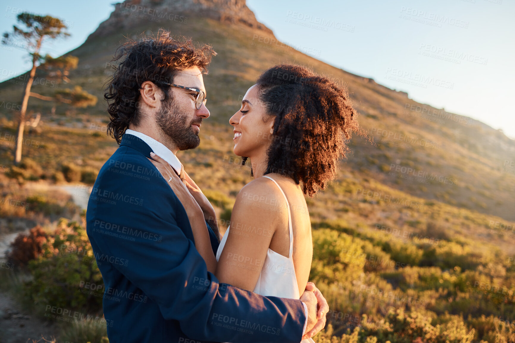 Buy stock photo Love, wedding and bride and groom on mountain for marriage ceremony, commitment and celebration. Trust, happy and interracial couple bonding, hug and smile on romantic holiday, vacation and honeymoon