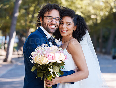 Buy stock photo Wedding portrait and flowers of couple with hug at romantic outdoor marriage event celebration together. Partnership, commitment and trust embrace of interracial bride and groom with excited smile.