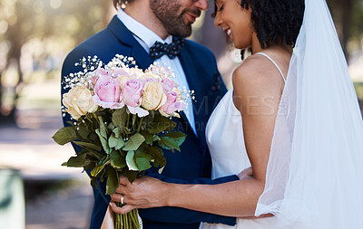 Buy stock photo Wedding, couple and hug with flower bouquet outdoor at marriage celebration event for bride and groom. Happy interracial man and woman at ceremony with trust, partnership and together for commitment