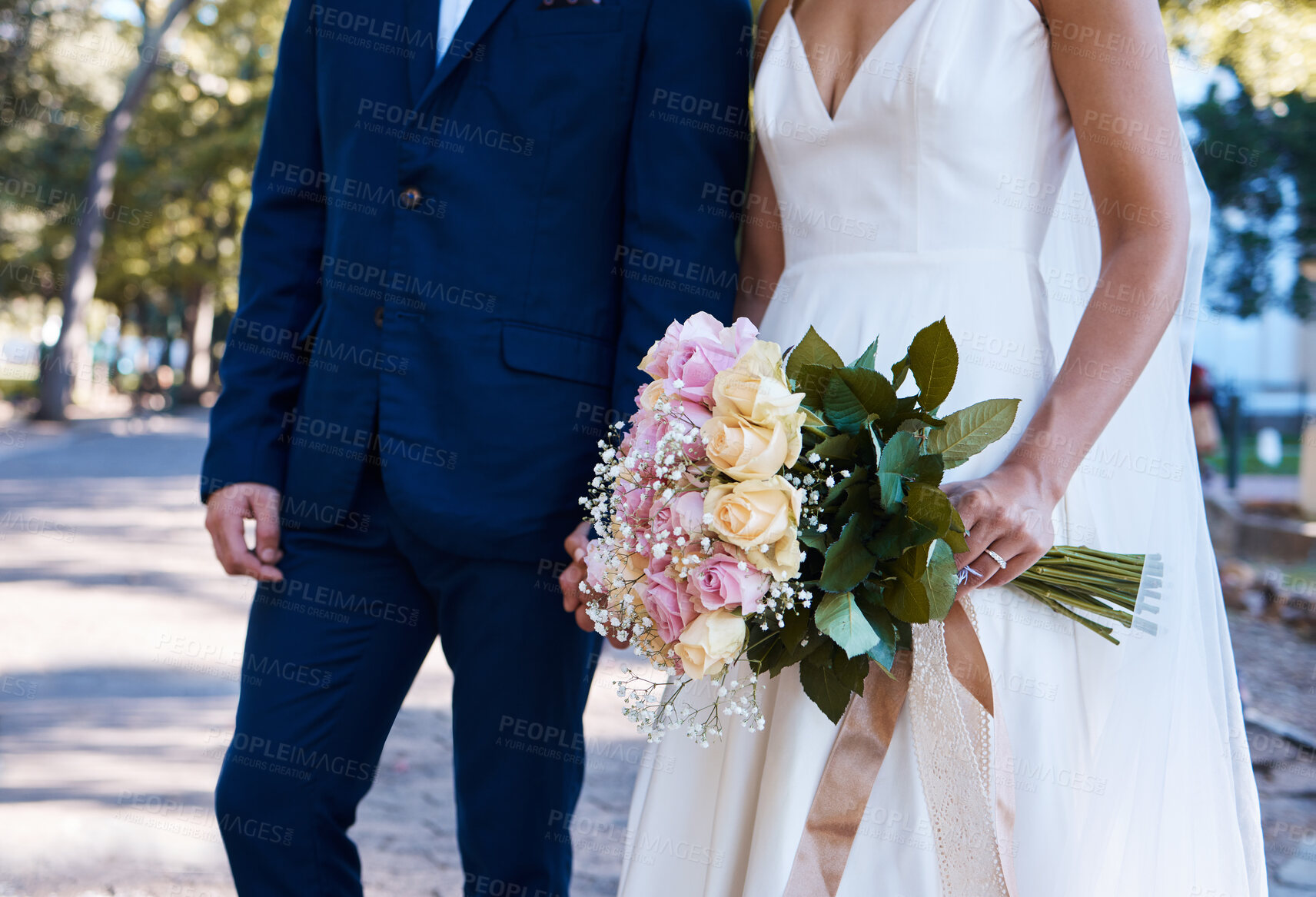 Buy stock photo Flowers, wedding and love of bride, groom and outdoor photograph at celebration, event or reception. Roses, bouquet and marriage of bridal couple, romance and park in commitment, union or partnership