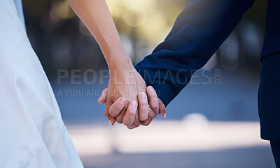 Buy stock photo Love commitment, wedding and couple holding hands outdoors for support. Partnership, diversity and affection, care or romance of interracial man, woman or bride and groom at ceremony for marriage day