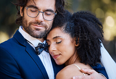 Buy stock photo Interracial couple, wedding and hug for love at marriage celebration event with commitment. Happy married man and woman together with trust, partnership and support or care with safety and security