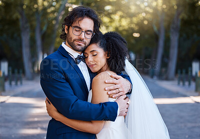 Buy stock photo Wedding, hug and love of a couple outdoor for marriage celebration event, commitment and care. Interracial man and woman at park with trust, partnership and embrace for gratitude for life partner