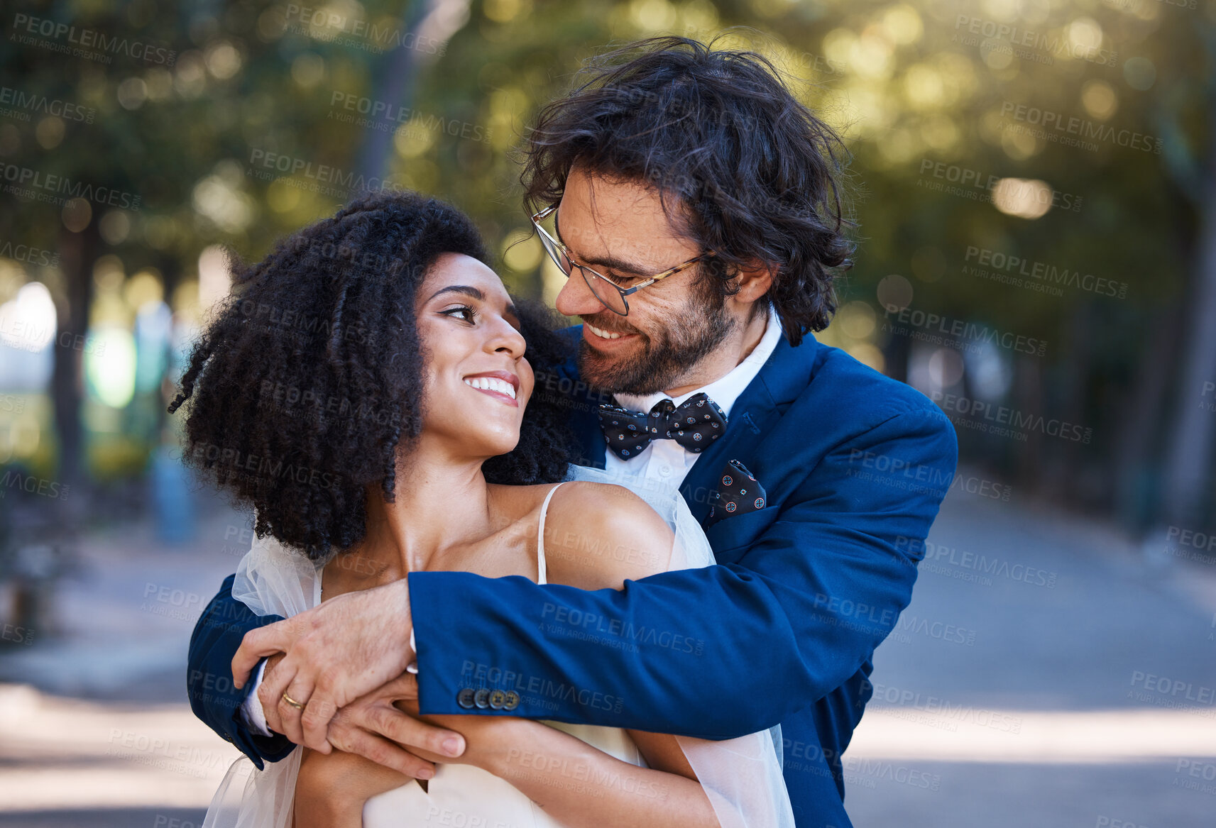 Buy stock photo Love, wedding and happy couple outdoor for marriage celebration event together with support. Interracial bride and groom at park with trust, partnership and a hug for commitment and care with a smile