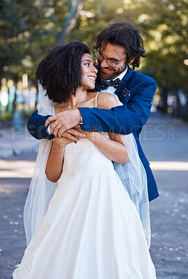 Buy stock photo Happy couple, hug and wedding celebration event outdoor with love, care and commitment. Interracial man and woman at park with trust, partnership and support while together in a healthy marriage