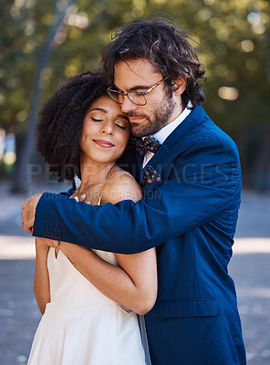 Buy stock photo Interracial wedding, black woman and man with hug with smile, happiness or future together. African bride, husband and diversity at outdoor marriage for love, embrace or eye contact in sunshine