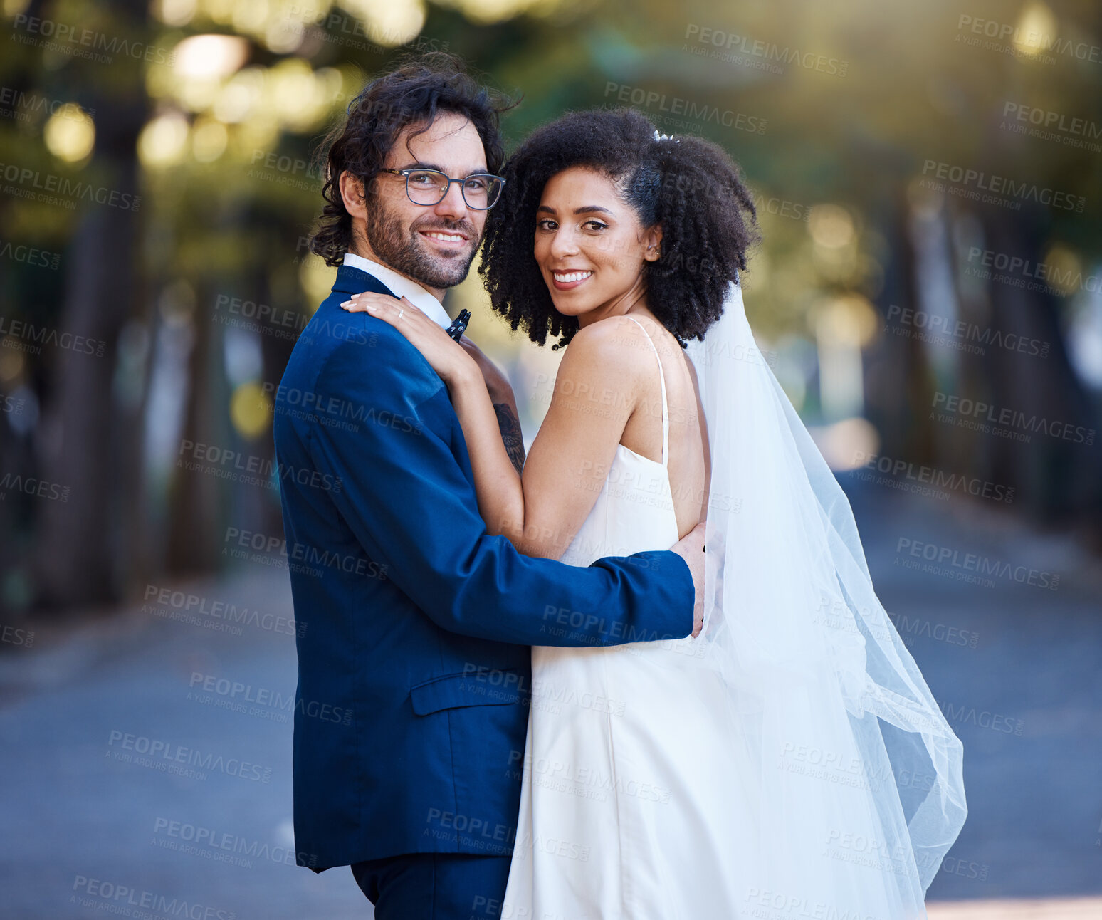 Buy stock photo Couple portrait, wedding and interracial love outdoor for marriage celebration event together with care. Happy married man and woman at park with trust, partnership and hug for happiness and security