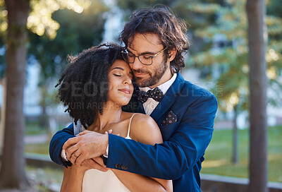 Buy stock photo Wedding, couple and hug of love outdoor for marriage celebration event together with support. Interracial man and woman at nature park with trust, partnership and commitment or safety and security