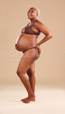 Buy stock photo Black woman, laughing or holding pregnant stomach on studio background in body empowerment, love or baby support. Smile, happy and pregnancy model in body underwear or ready for motherhood on mock up