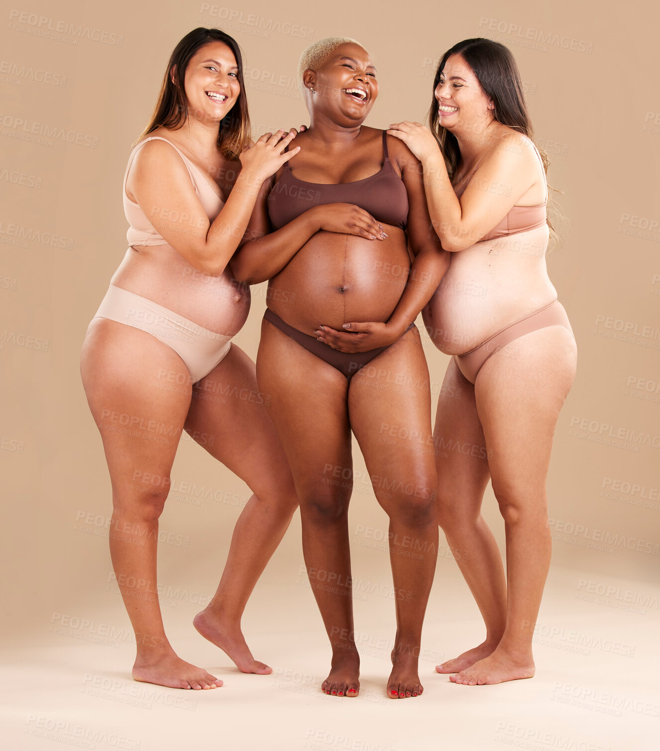 Buy stock photo Pregnant body, laughing and women diversity on studio background in empowerment, baby support and community. Smile, happy and pregnancy friends in underwear with funny family planning joke