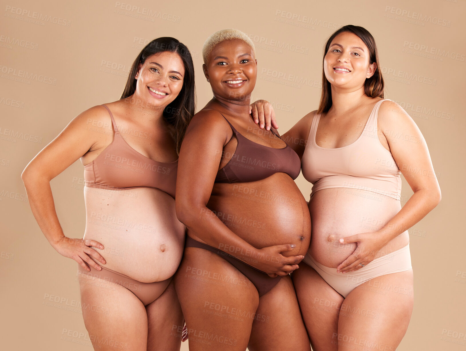 Buy stock photo Portrait, beauty and tummy with pregnant friends in studio on a beige background for diversity or motherhood. Family, love and pregnancy with a woman friend group showing their baby bump stomach