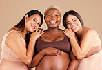 Portrait, beauty and happy with pregnant friends in studio on a beige background for diversity or motherhood. Family, love and pregnancy with a woman friend group showing their baby bump stomach