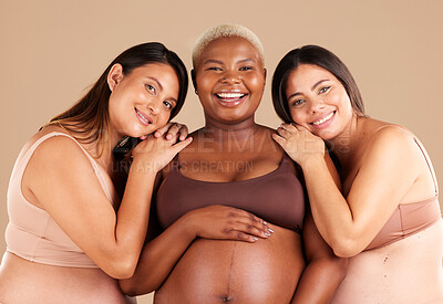 Buy stock photo Portrait, beauty and happy with pregnant friends in studio on a beige background for diversity or motherhood. Family, love and pregnancy with a woman friend group showing their baby bump stomach