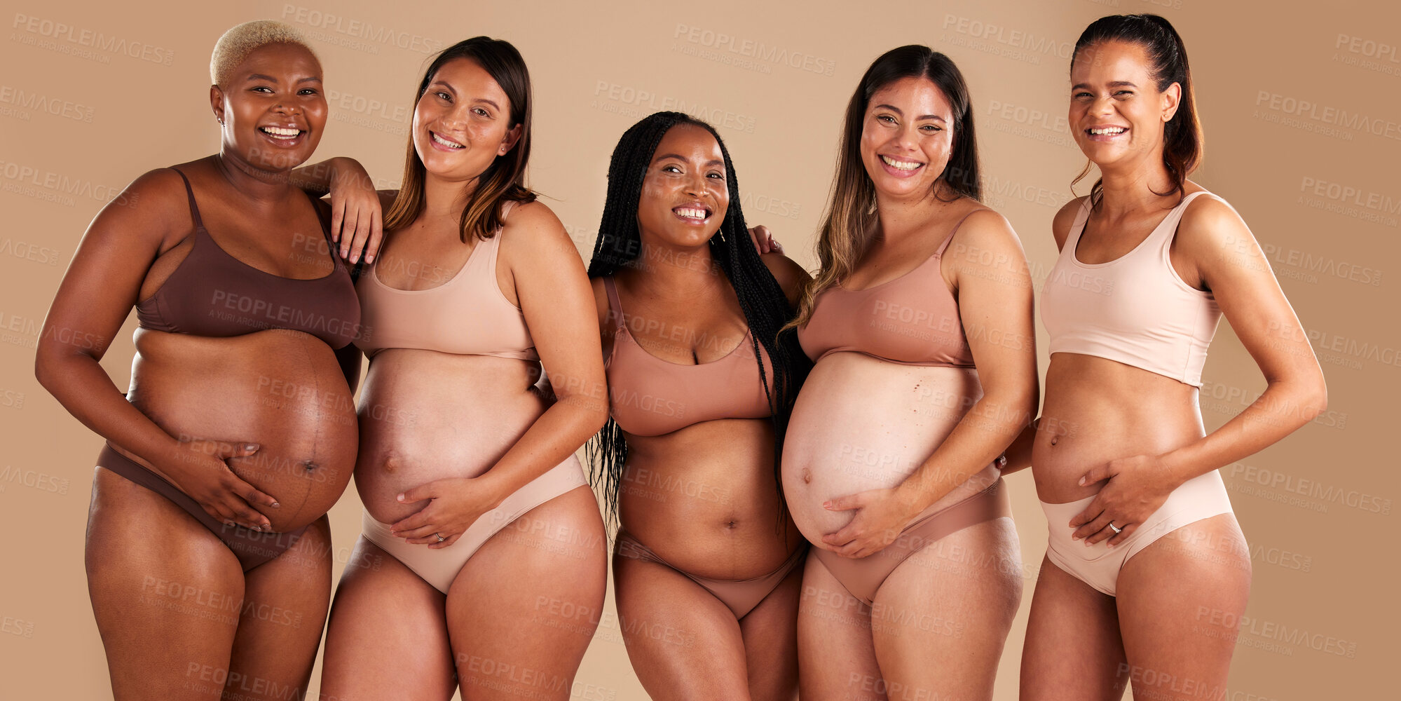 Buy stock photo Pregnancy body, portrait and bonding women on studio background in diversity empowerment, baby support and community. Smile, happy and pregnant friends in underwear with stomach growth, touch or love