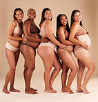 Portrait, pregnant and happy women in row on studio background in community, diversity or baby support group. Smile, happy or bonding mothers with pregnancy stomach, underwear or healthcare wellness