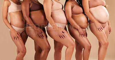 Buy stock photo Pregnant body, women or stomach in row on studio background in community, diversity or baby support group. Friends, people or bonding mothers in underwear for belly growth or healthcare development