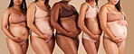 Pregnancy, body or women touching stomach in support, love or community diversity on studio background. Pregnant, friends or mothers in underwear for belly growth, empowerment or healthcare wellness