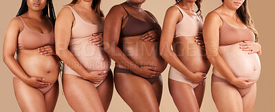 Buy stock photo Pregnancy, body or women touching stomach in support, love or community diversity on studio background. Pregnant, friends or mothers in underwear for belly growth, empowerment or healthcare wellness