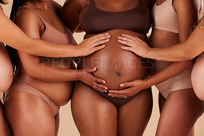 Buy stock photo Women, hands or touching pregnancy stomach of black woman on studio background in growth support, love or community. Zoom, body or friends in pregnant underwear and belly feeling for baby health kick