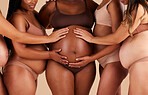 Women, hands or touching pregnancy belly of black woman on studio background in growth support, love or community. Zoom, body or mothers in pregnant underwear and stomach feeling for baby health kick