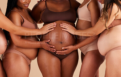 Buy stock photo Women, hands or touching pregnancy belly of black woman on studio background in growth support, love or community. Zoom, body or mothers in pregnant underwear and stomach feeling for baby health kick