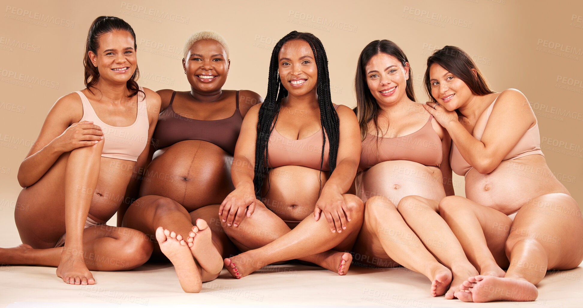 Buy stock photo Portrait, bonding and pregnant women sitting on floor in community, diversity support or body empowerment. Smile, happy and pregnancy friends in underwear for healthcare wellness, future baby or love