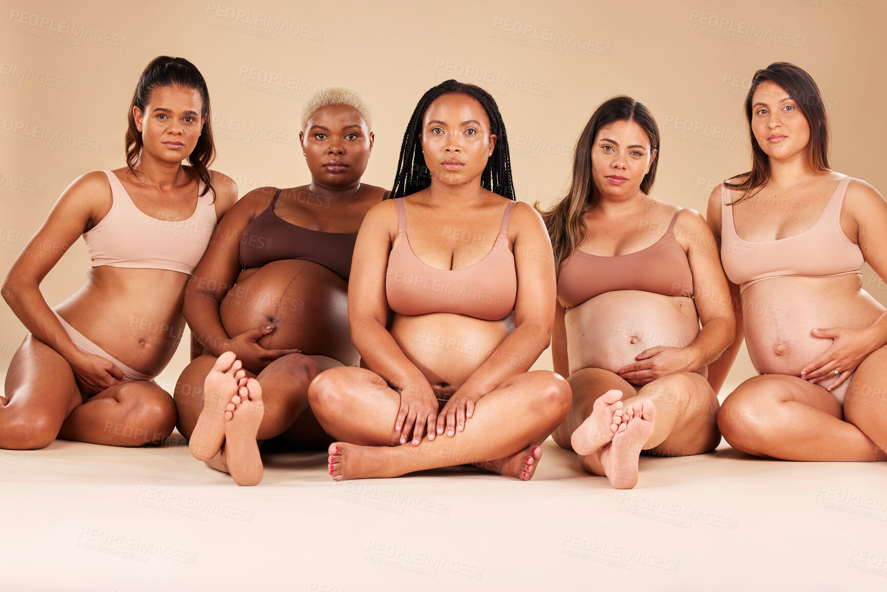 Buy stock photo Pregnancy, portrait and sitting women in underwear for community bonding, diversity support or body empowerment. Floor, pregnant or friends in healthcare wellness, strong mindset or mothers day pride