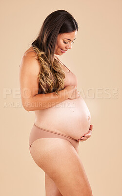 Buy stock photo Pregnancy care, underwear and studio woman with smile, happy and excited for baby, stomach growth or motherhood. Gynecology, maternity or pregnant model feeling abdomen with healthcare, love and hope