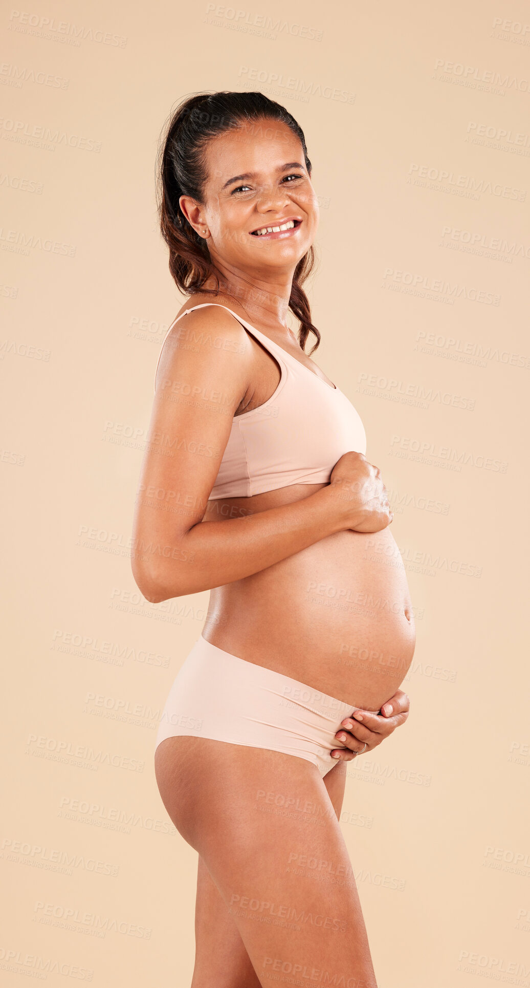 Buy stock photo Pregnancy portrait, lingerie or studio woman with smile, happy and excited for baby, stomach growth or motherhood. Gynecology care, maternity wellness or pregnant model with healthcare, love and hope