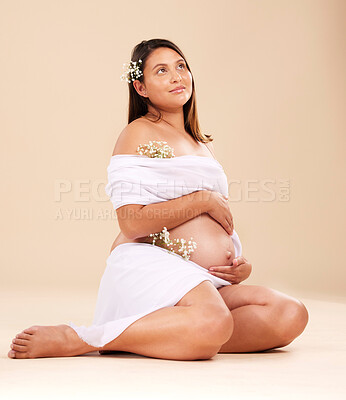 Buy stock photo Pregnancy, pregnant woman with flowers sitting, beauty and glow isolated on studio background. Skin, shine and natural cosmetics with nature, happy mother with prenatal cosmetic care mockup