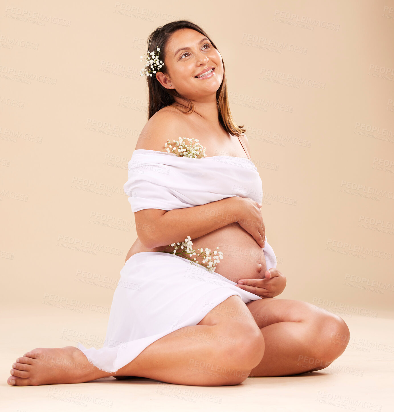 Buy stock photo Pregnancy, pregnant woman and smile with flowers sitting, beauty and glow isolated on studio background. Skin, shine and natural cosmetics with nature, happy mother with prenatal cosmetic care mockup