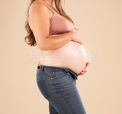 Buy stock photo Pregnant, woman and stomach on studio background for body, maternity wellness and healthcare. Closeup abdomen, belly and pregnancy of mother model for beauty, gynecology and natural birth of new life